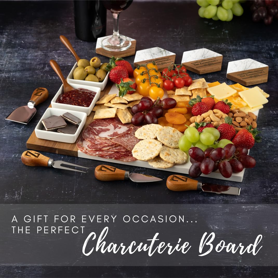 Charcuterie board with meats, cheeses, fruits, and accompaniments on a dark surface.
