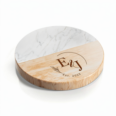 A round coaster with a marble top and a wooden bottom, featuring an engraved initial 'E' and the text 'E&J Est. 2023'.
